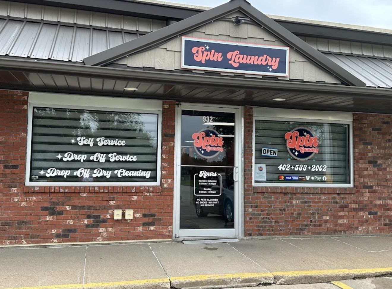 The Spin Laundry storefront at 932 Grant Street in Blair, Nebraska, with the retro Spin Laundry sign above the door