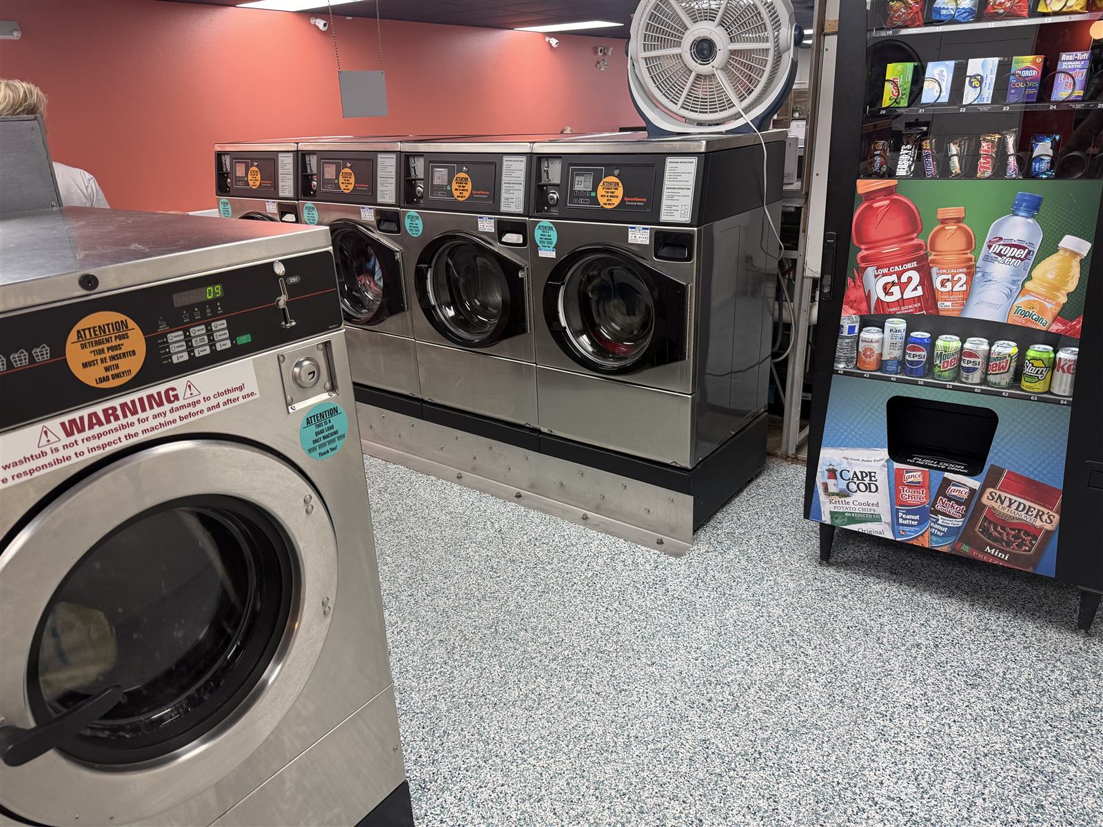 A row of Speed Queen commercial front-load washers inside Spin Laundry